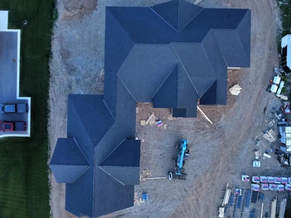 Completed residential roof installation with new asphalt shingles
