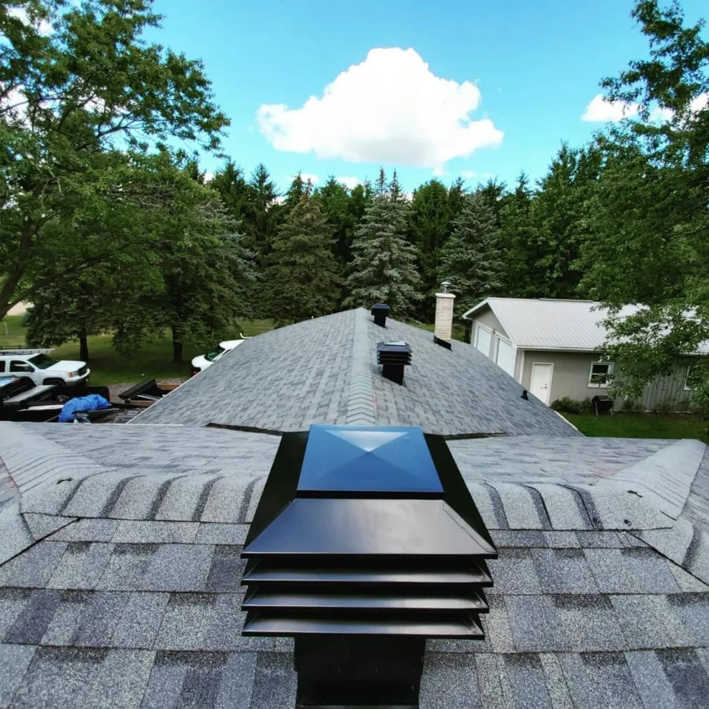 Roofer installing ice and water shield underlayment