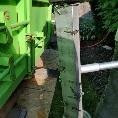 Crew cleaning up job site after roof installation